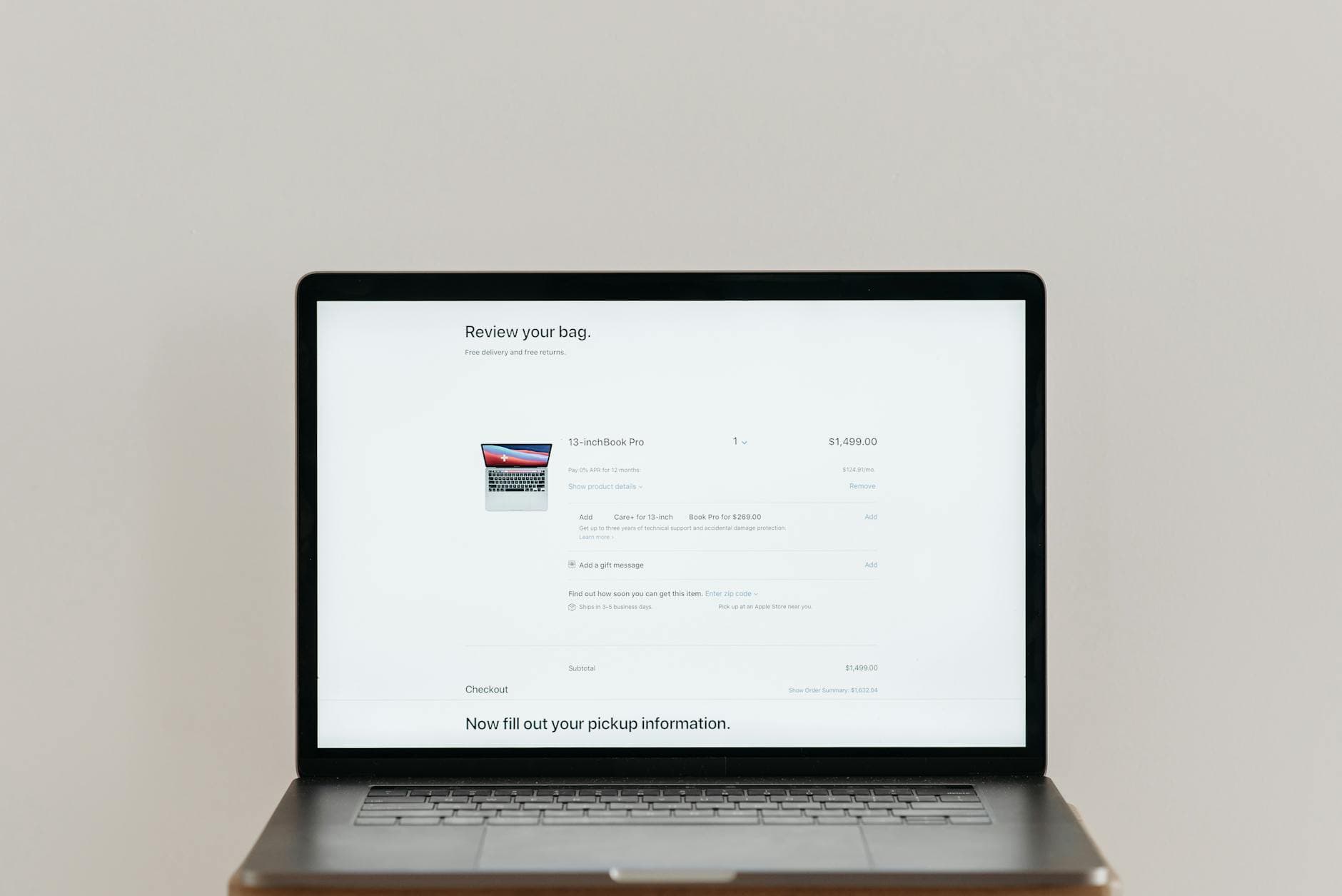 Minimalist laptop showing an online checkout screen on a white background, ideal for tech context.
